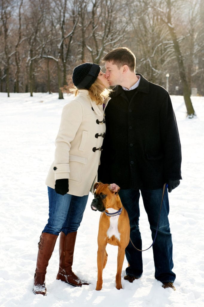 family portrait outside in snow with dog