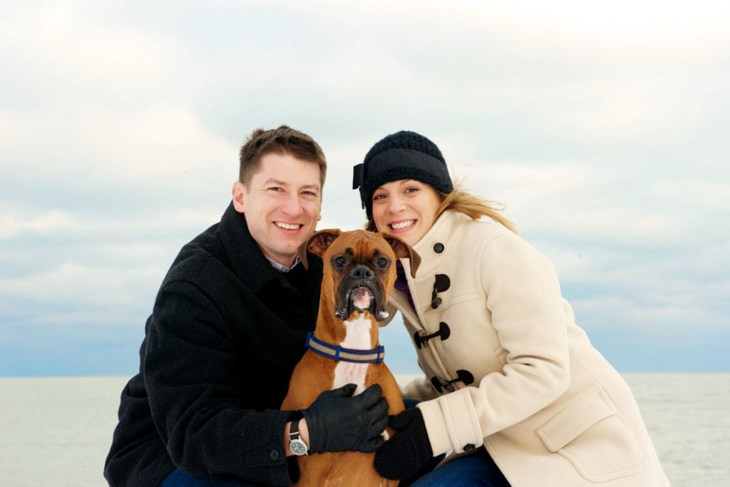 family portrait outside in snow with dog